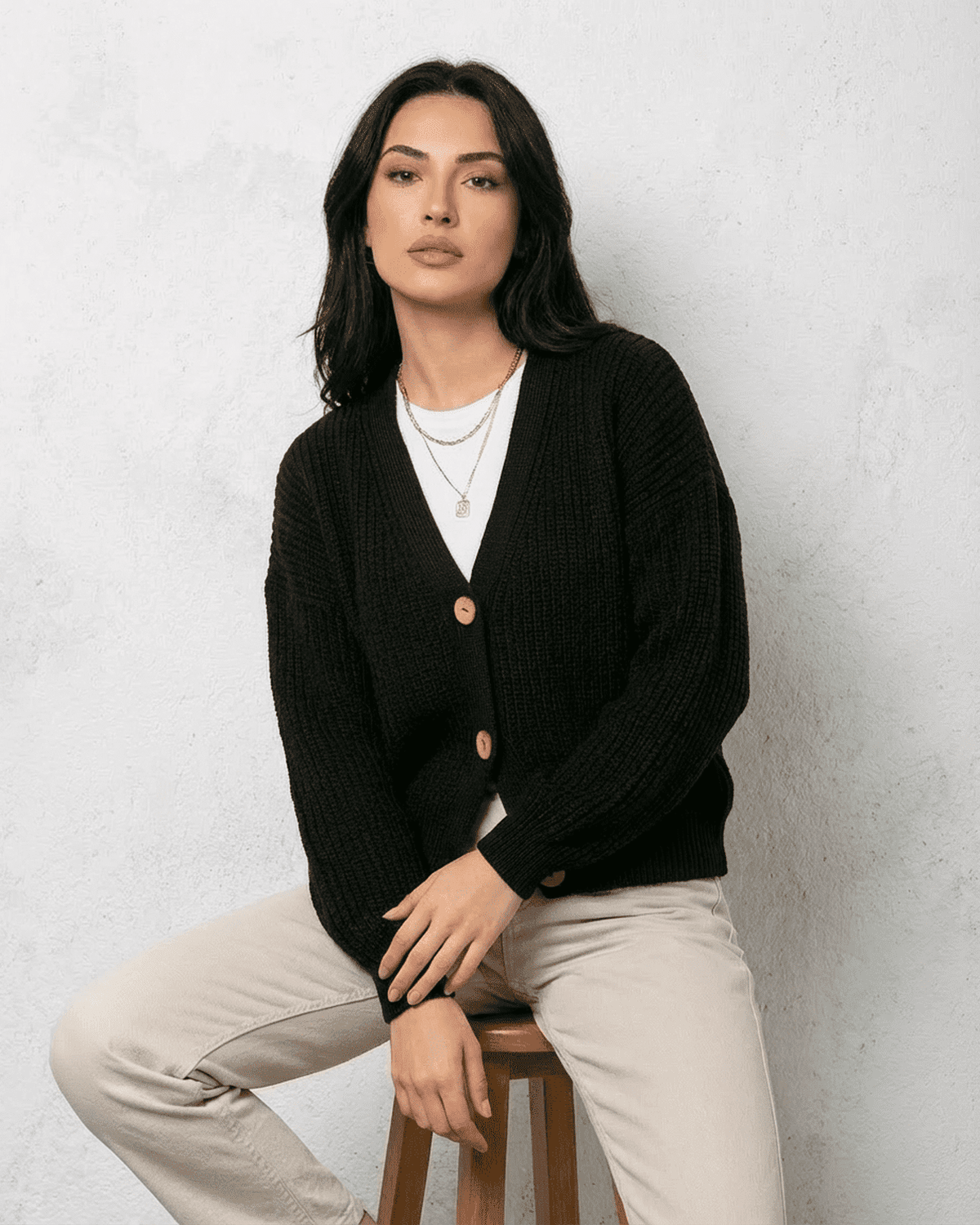 Noir Cardigan by SLIMONA, featuring a stylish V-neck, button detail, and cozy black knitwear for modern elegance.