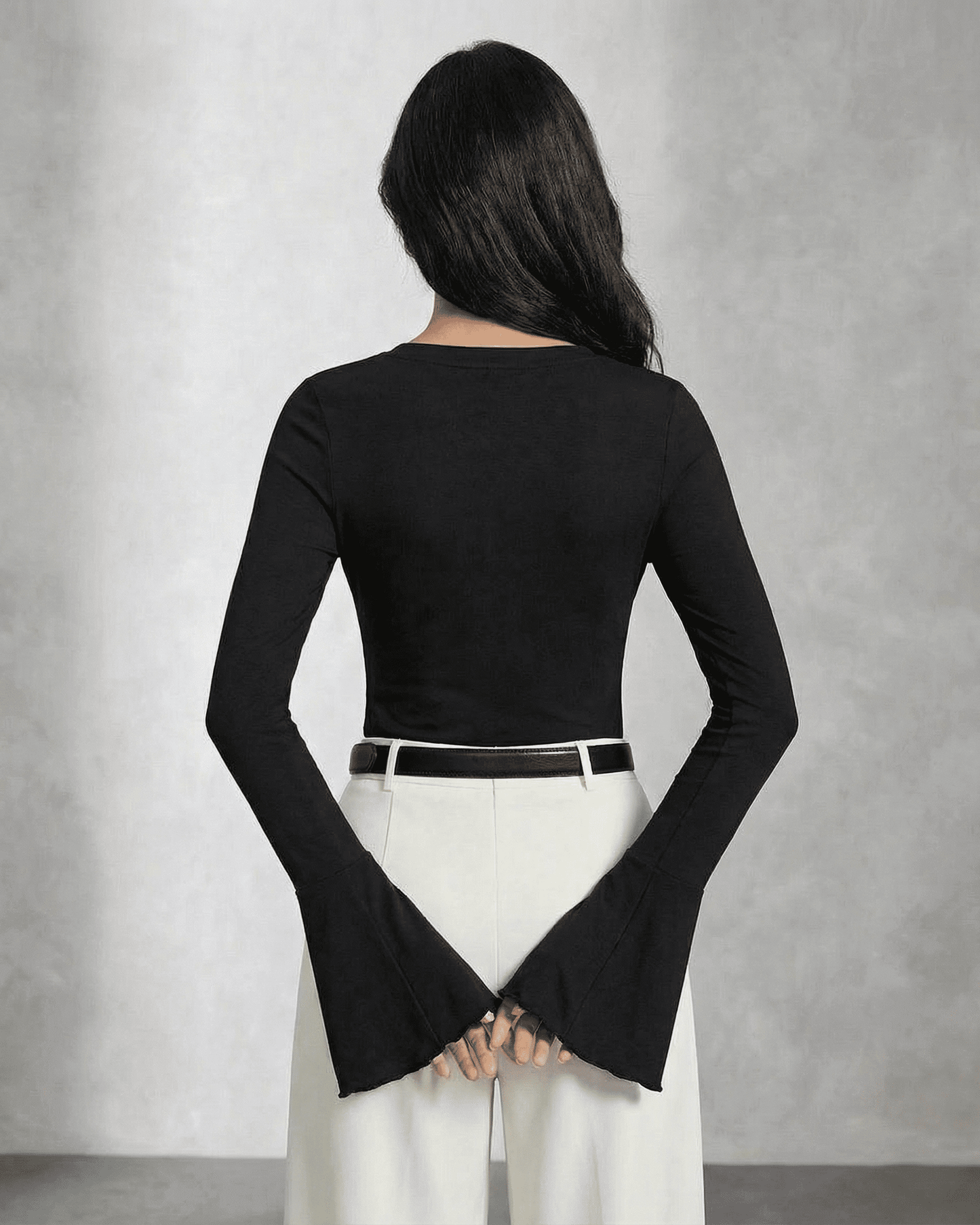 Back view of a model wearing the SLIMONA Nova Blouse featuring elegant flare sleeves and a slim fit design.