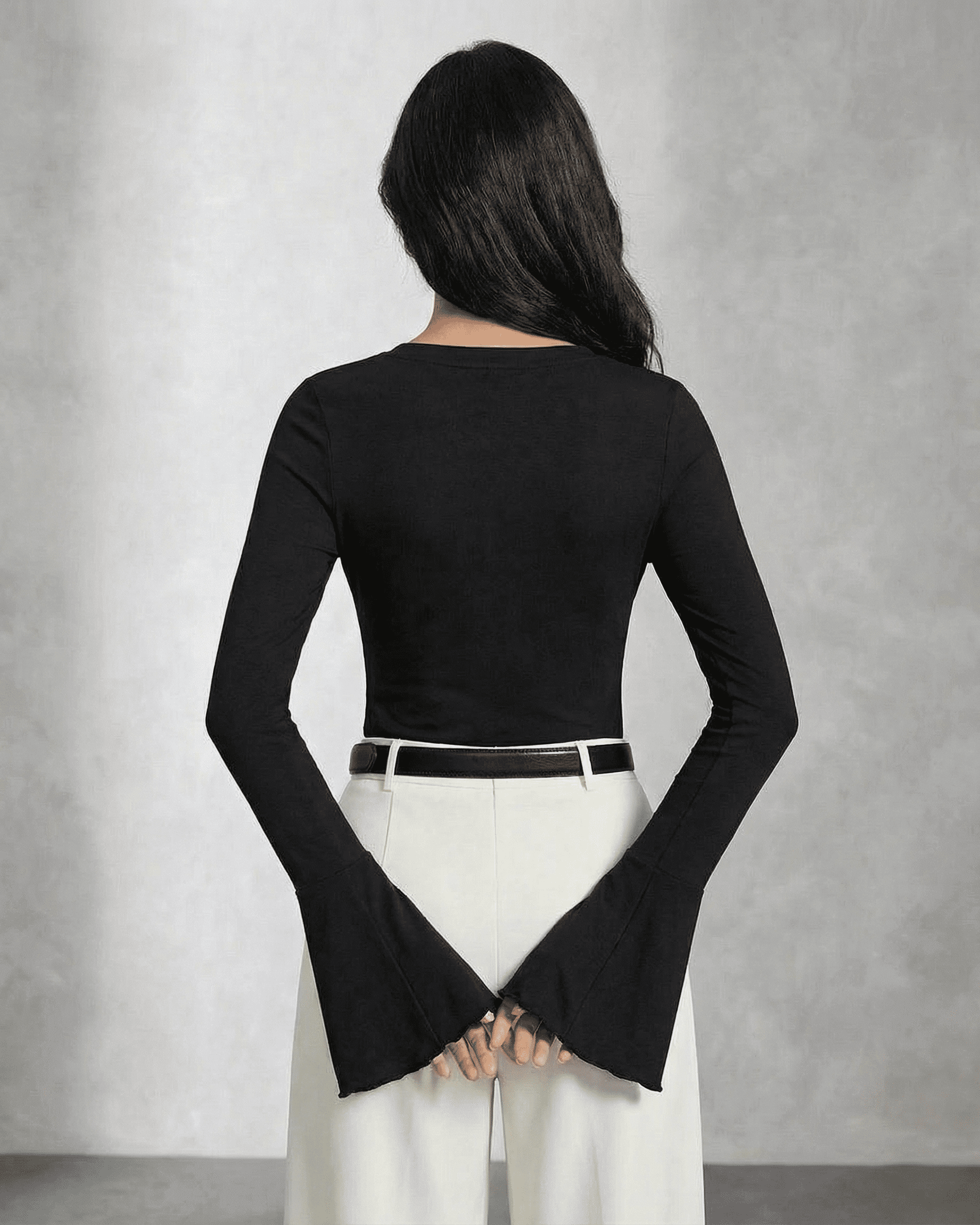 Back view of a model wearing the SLIMONA Nova Blouse featuring elegant flare sleeves and a slim fit design.