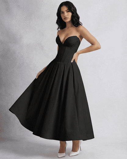 Model wearing the Nova Midi Dress by SLIMONA, a sleek strapless corset A-line dress in black.