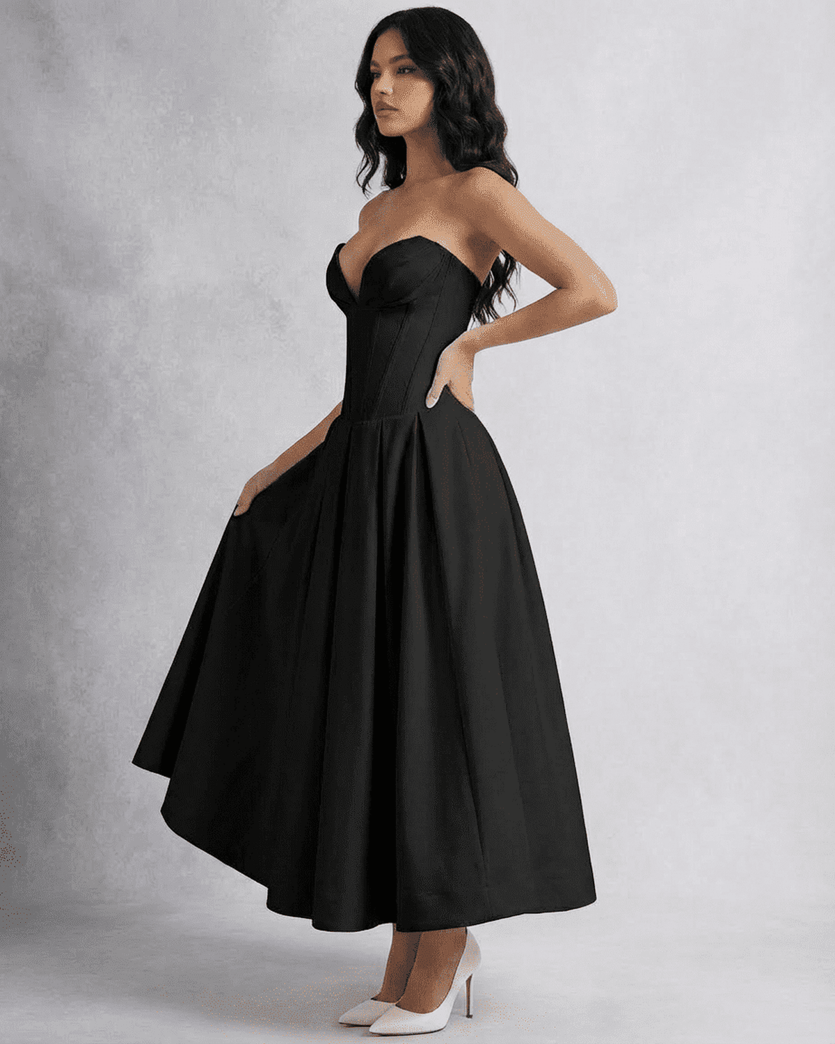 Model wearing the Nova Midi Dress by SLIMONA, a sleek strapless corset A-line dress in black.