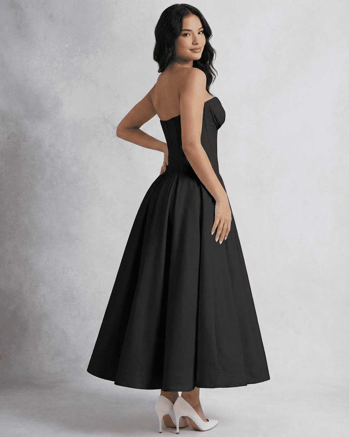 Model showcasing the elegant Nova Midi Dress by SLIMONA, featuring a strapless design and flowing A-line silhouette.