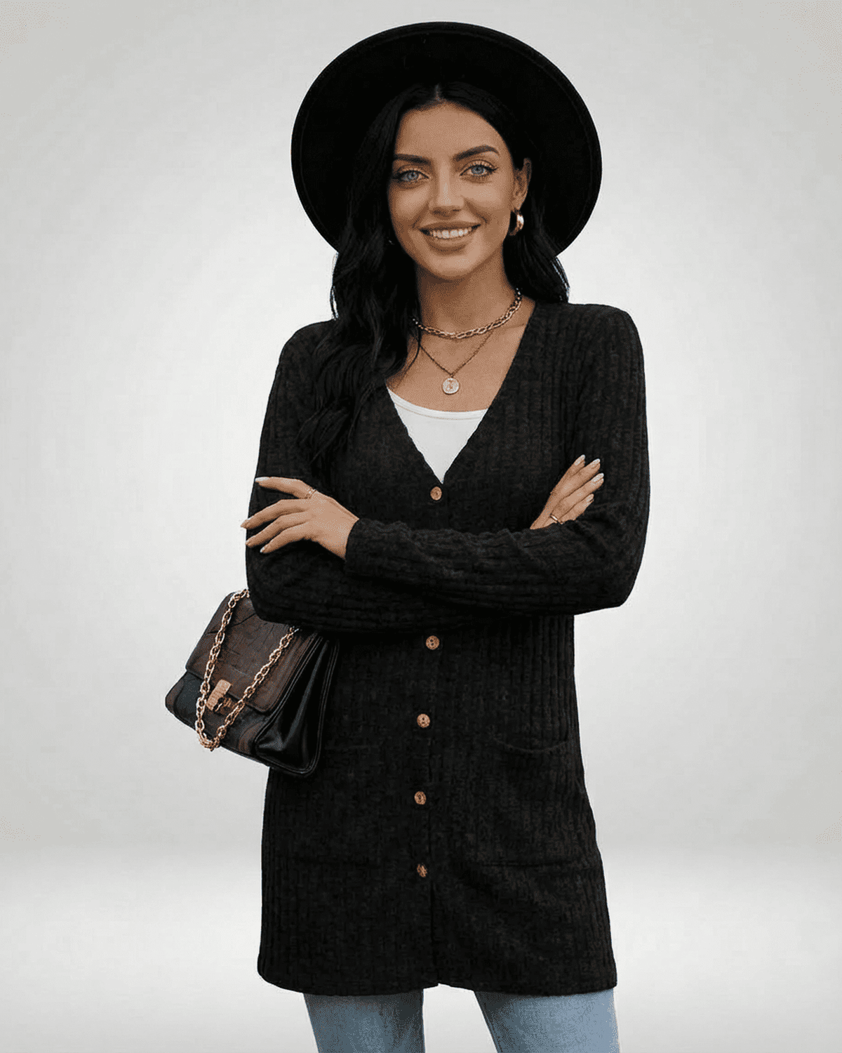 Stylish woman wearing Nyx Cardigan by SLIMONA, showcasing a longline knit silhouette and V-neckline.
