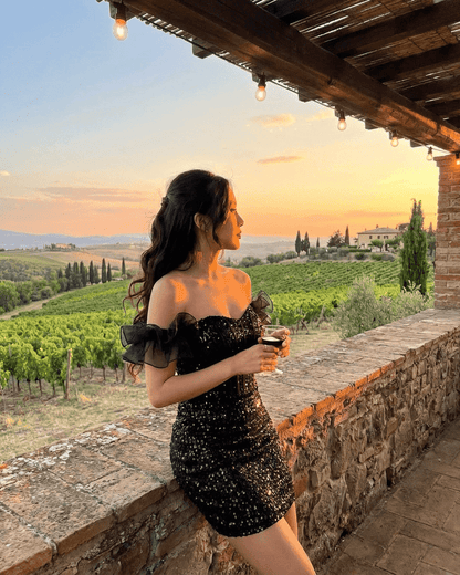 Obsidian Mini Dress by SLIMONA - Black Sequin Off-The-Shoulder Dress with Ruffle Sleeves in a Scenic Vineyard Setting