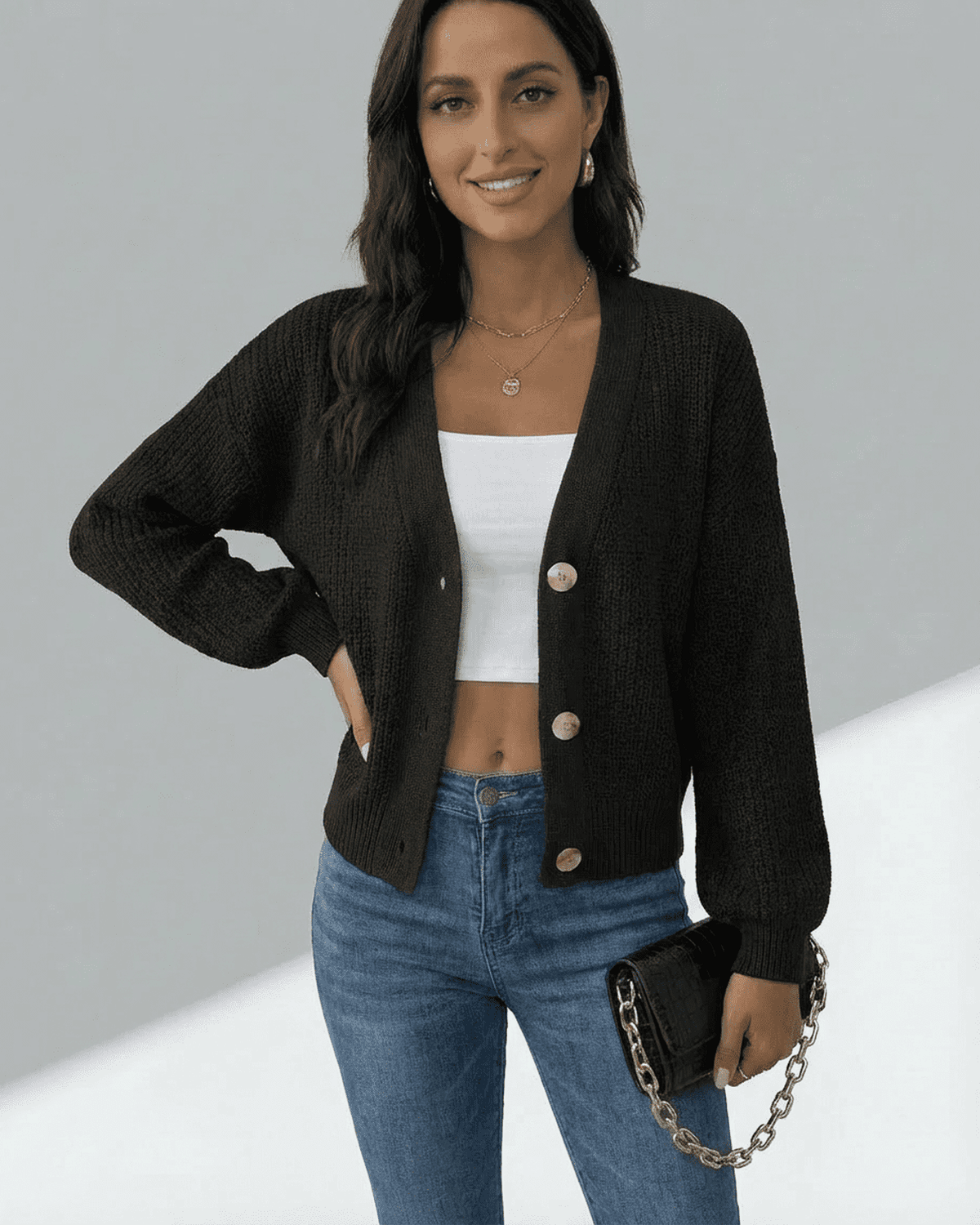 Model wearing the Orion Cardigan by SLIMONA, featuring a long sleeve, V-neckline, and button-front design.