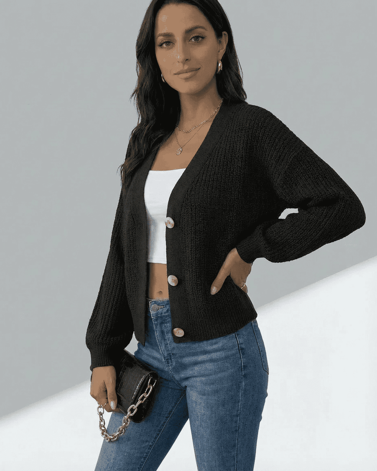 Model wearing the Orion Cardigan from SLIMONA, showcasing a stylish long sleeve v-neck knitwear in black.
