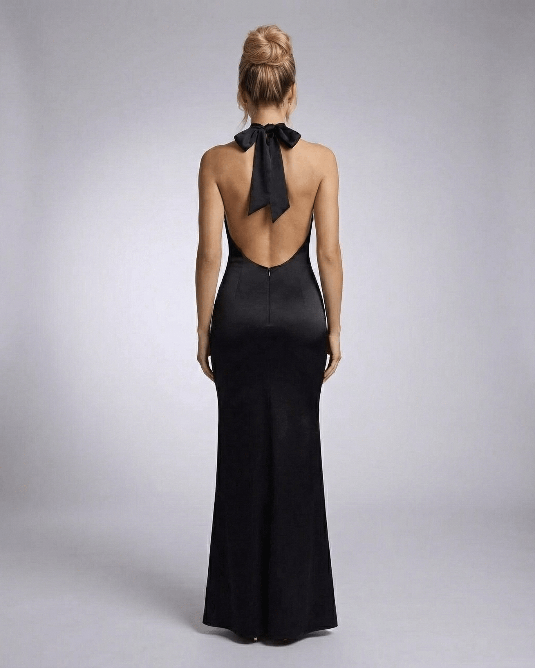 Orion Maxi Dress by Lauven, showcasing a halter neck and sleek bodycon silhouette from the back.
