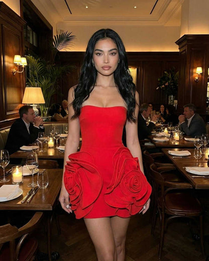 Orion Mini Dress by Lauven, elegant strapless red dress with 3D floral accents in a dining setting.