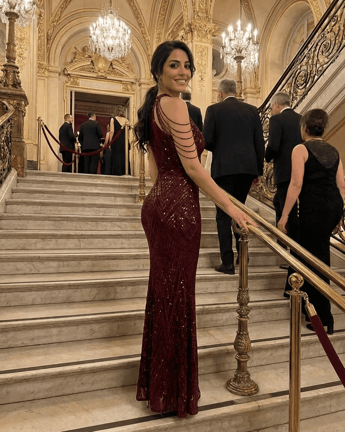 Model showcasing the Ruby Maxi Dress by SLIMONA, a glamorous sequin halter mermaid gown in deep red.