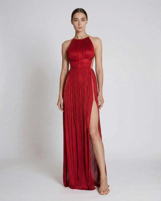 Saffron Maxi Dress by Lauven, pleated red sheath gown with halter neckline and high slit showcased on model.