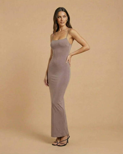 Sahara Maxi Dress by SLIMONA in soft taupe, showcasing a sleek backless design and elegant silhouette.