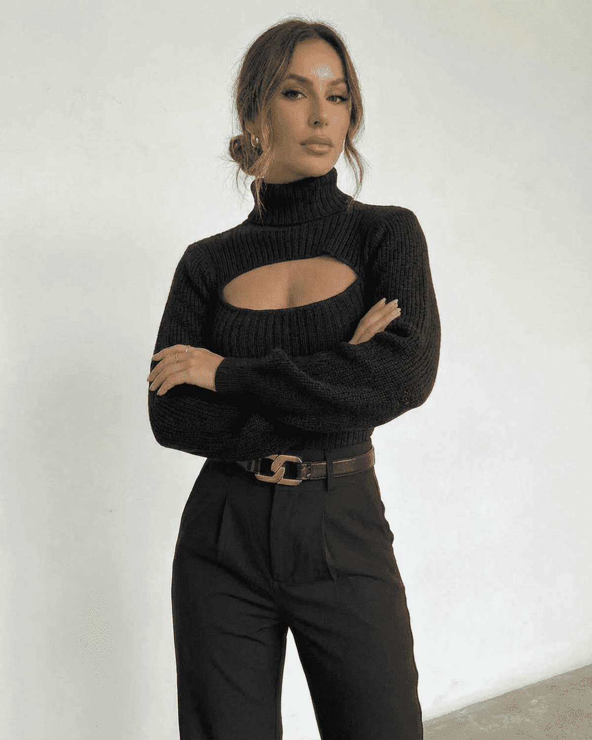 Sarina Sweater by SLIMONA - Chic hollow out mock neck black slim fit sweater worn with stylish high-waisted pants.