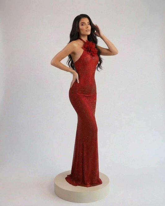 Scarlet Maxi Dress by SLIMONA features halter neck, floral detail, and floor-length silhouette in rich red shimmer.