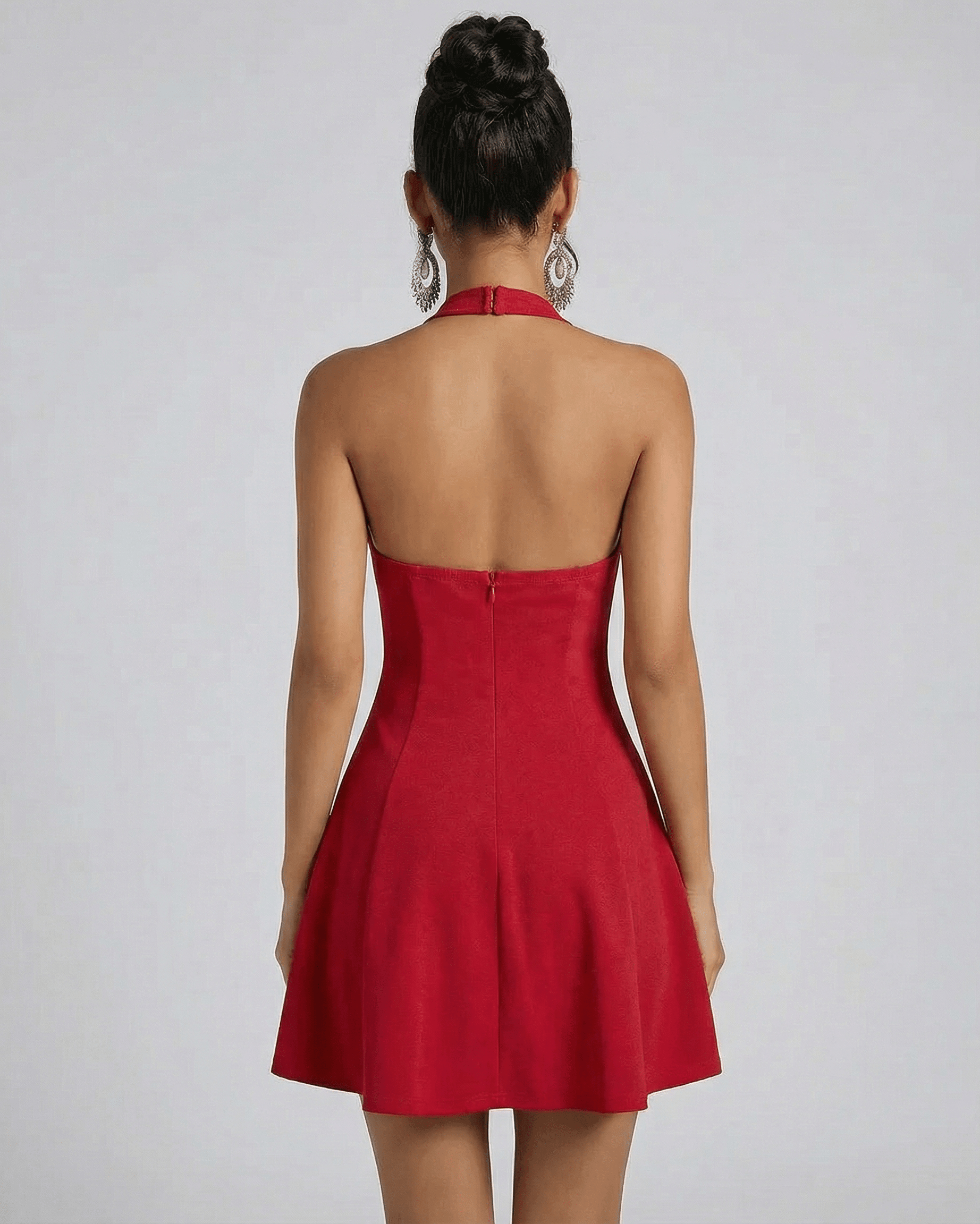 Back view of a model wearing the SLIMONA Scarlet Mini Dress in red with a flared silhouette and halter neck design.
