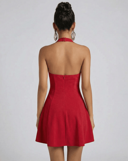 Back view of a model wearing the SLIMONA Scarlet Mini Dress in red with a flared silhouette and halter neck design.