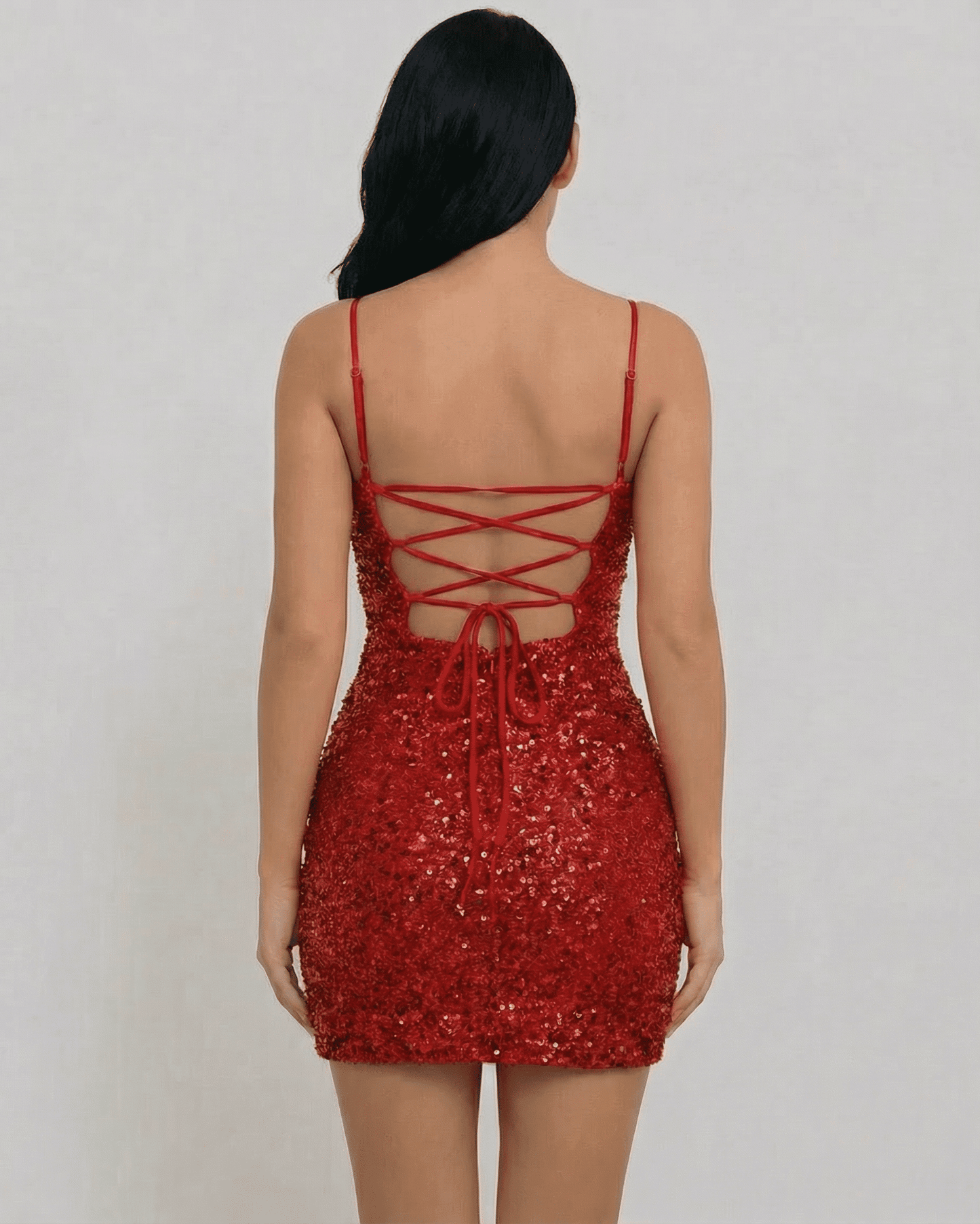 Back view of the Scarlet Mini Dress by SLIMONA, featuring a lace-up design and stunning red sequins.