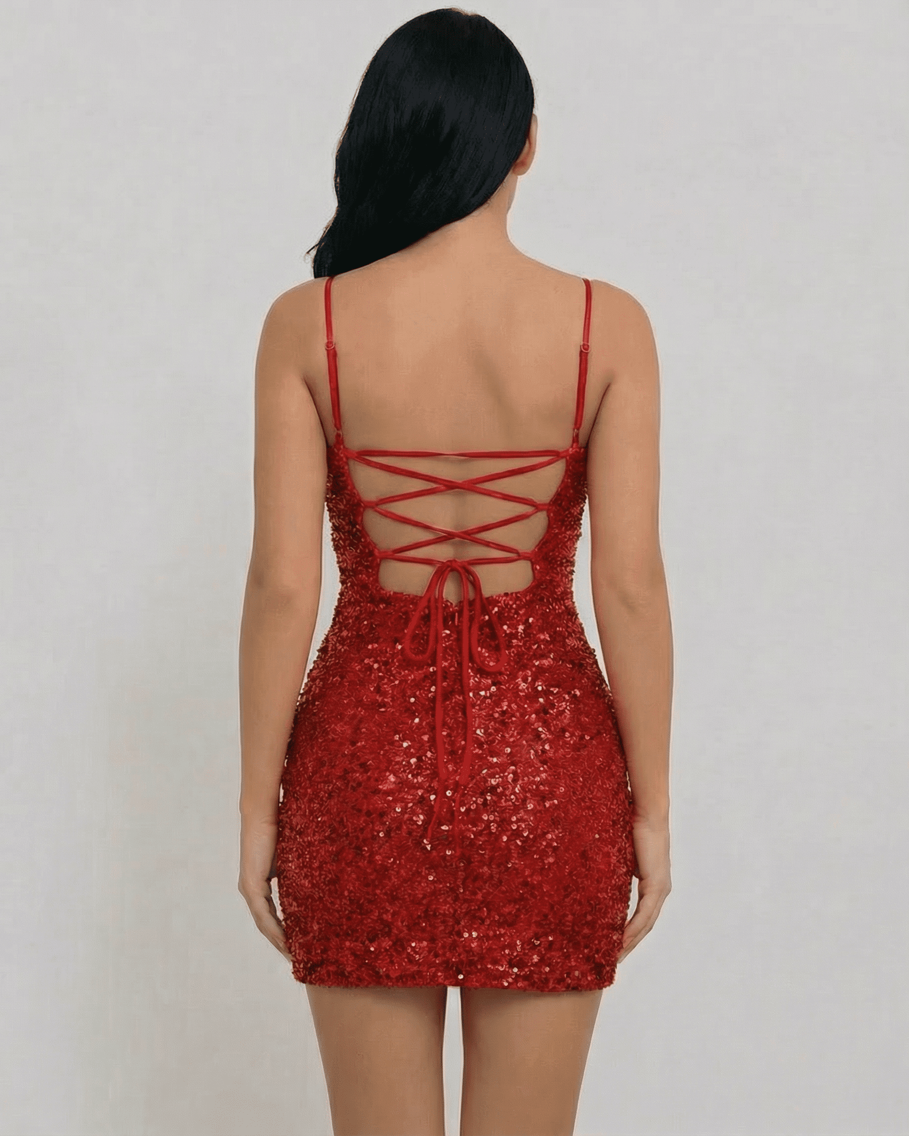 Back view of the Scarlet Mini Dress by SLIMONA, featuring a lace-up design and stunning red sequins.