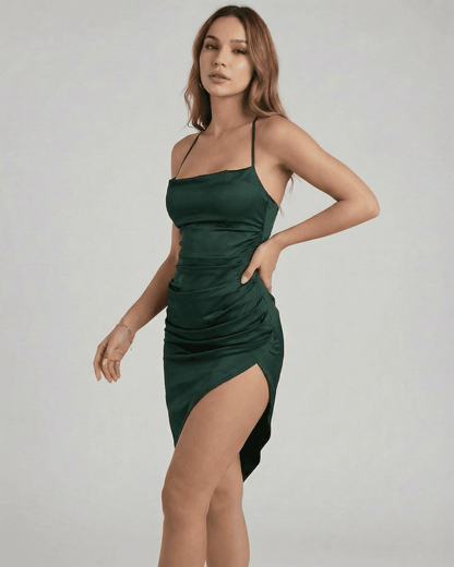 Selene Midi Dress by SLIMONA in green, showcasing a sleek satin silhouette with elegant pleating and a flattering fit.