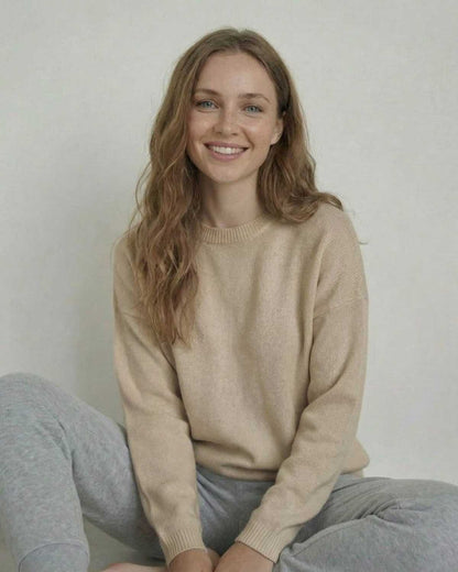 Siena Pullover in soft wool, showcased by a smiling woman in a relaxed pose, wearing SLIMONA's stylish design.