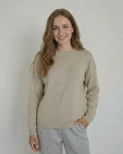 Woman wearing the Siena Pullover by SLIMONA, a soft wool knit sweater with a relaxed fit and round neck.