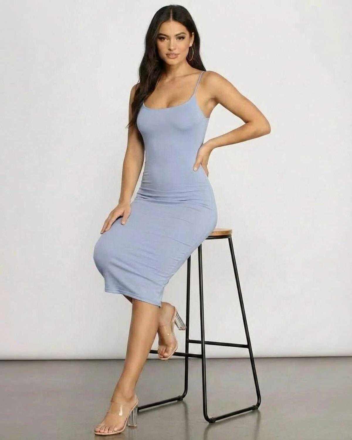 Model wearing Sienna Midi Dress by SLIMONA, showcasing its elegant fit and sleek knit design.