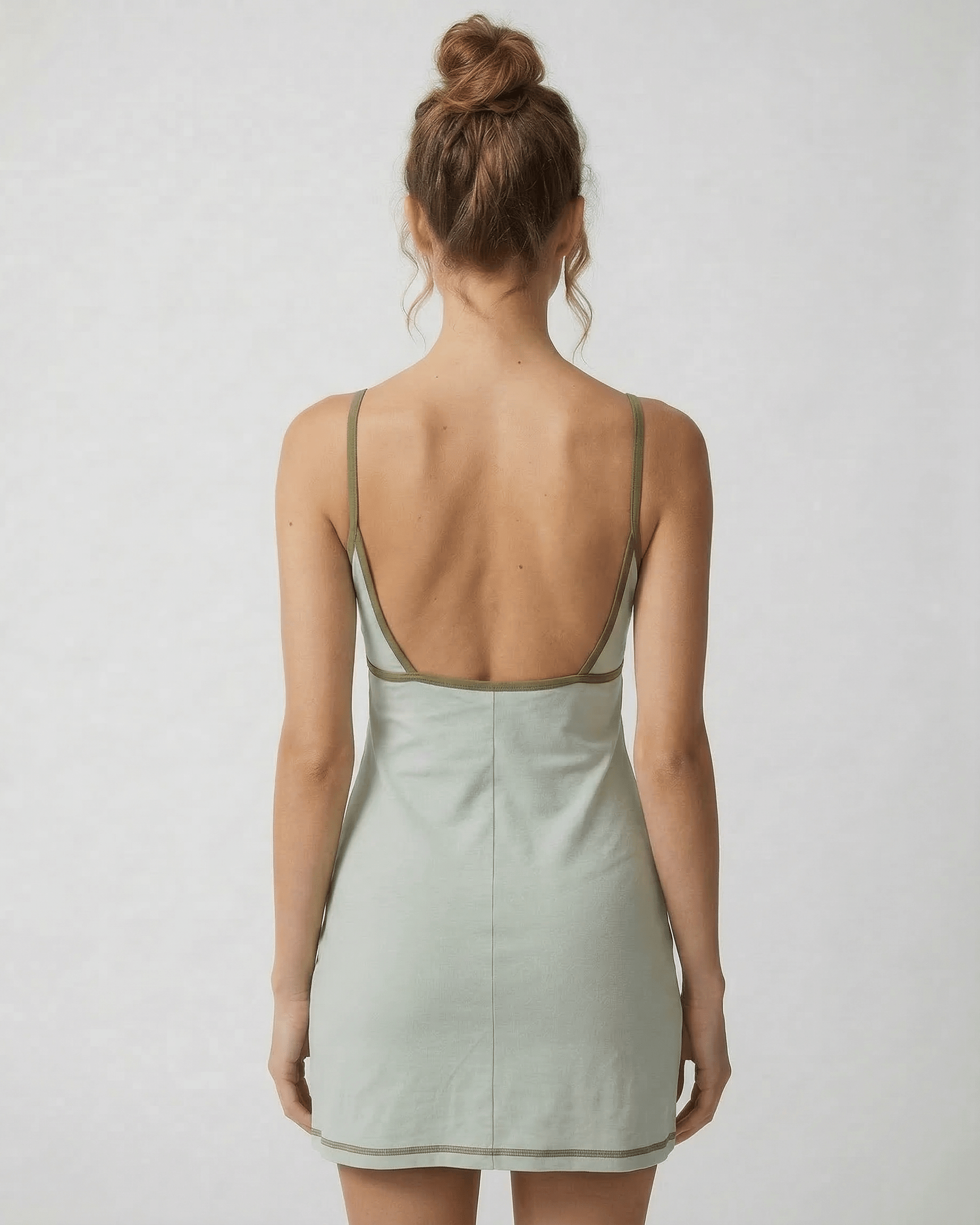 Sierra Mini Dress by Lauven showcasing an olive-trimmed back cut-out detail in pastel green.