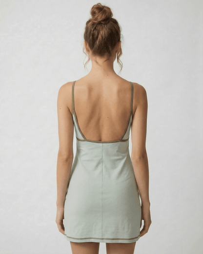 Sierra Mini Dress by Lauven showcasing an olive-trimmed back cut-out detail in pastel green.
