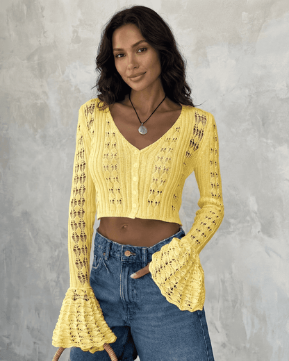 Stylish model wearing Solana Cardigan by SLIMONA, a yellow cropped cotton knit with flare sleeves.
