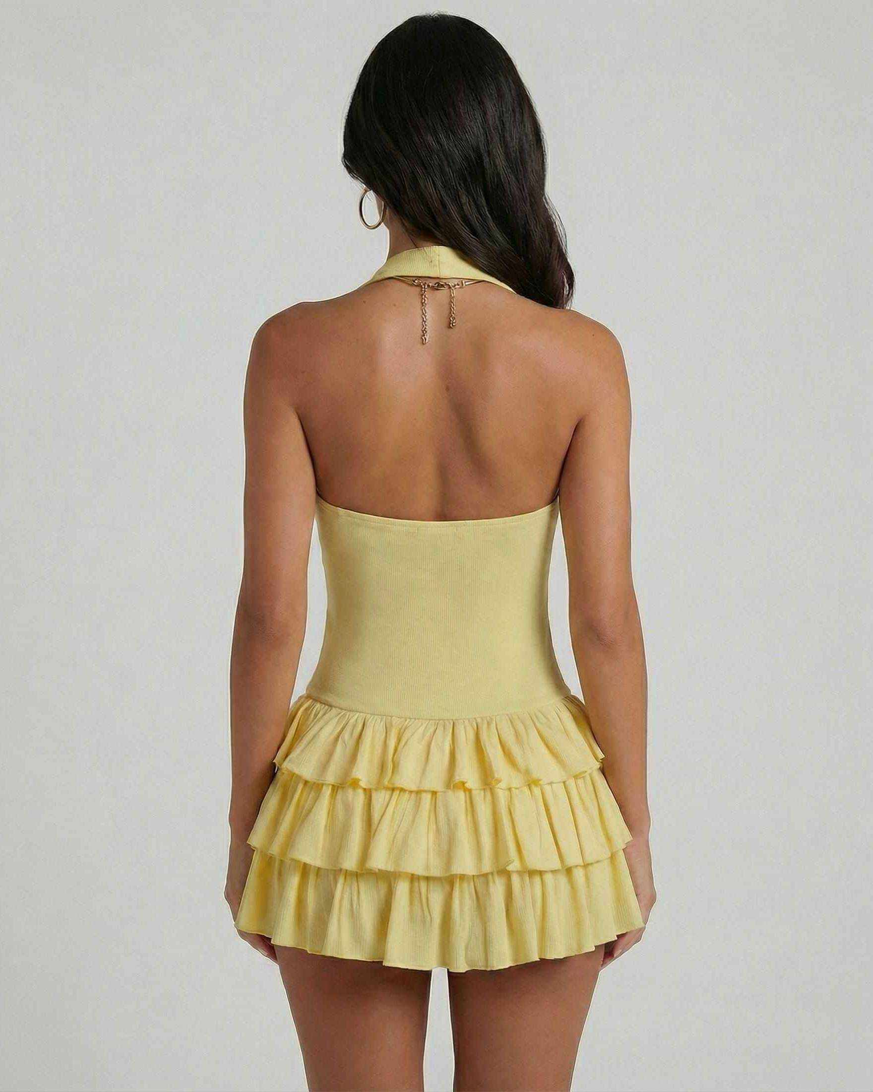 Back view of Solara Mini Dress by SLIMONA, featuring yellow tiered skirt and square neckline.