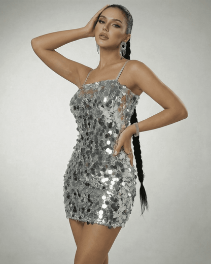 Stella Mini Dress by SLIMONA, silver sequin off-the-shoulder mini dress showcasing a high waist and sleeveless design.