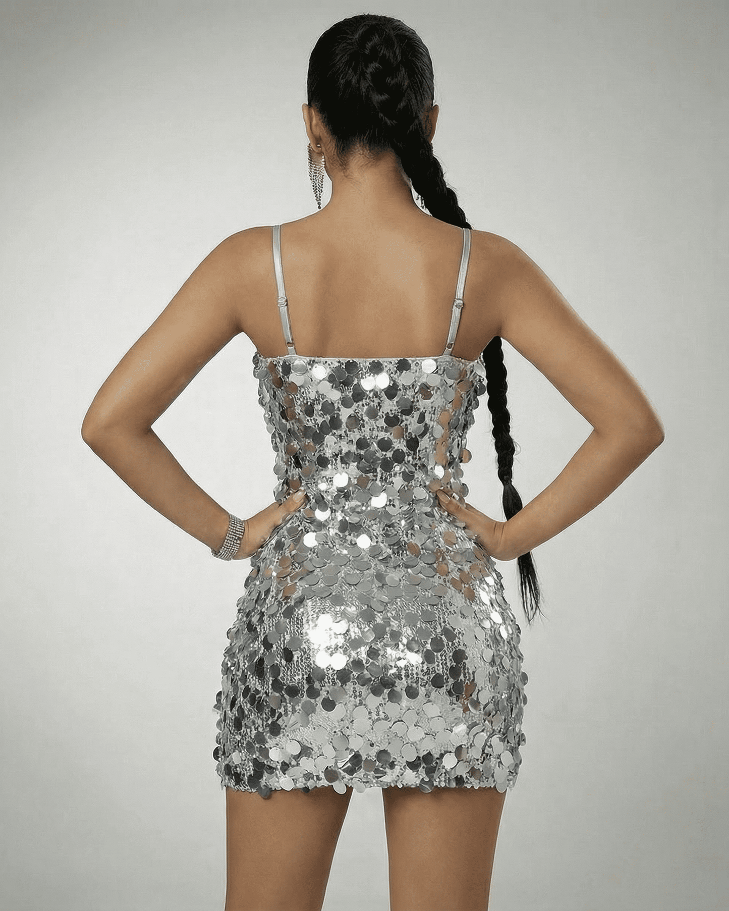 Stella Mini Dress by SLIMONA, showing the back view of a silver sequin off-the-shoulder mini dress.