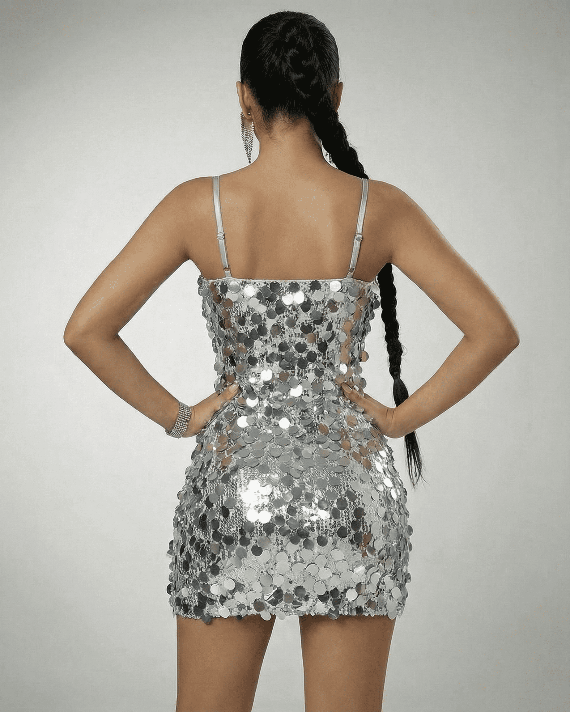 Stella Mini Dress by SLIMONA, showing the back view of a silver sequin off-the-shoulder mini dress.