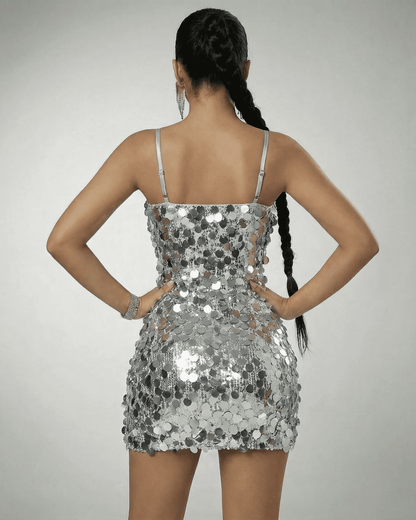 Stella Mini Dress by SLIMONA, showing the back view of a silver sequin off-the-shoulder mini dress.