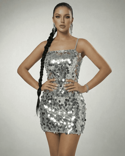 Stella Mini Dress by SLIMONA, silver sequin off-the-shoulder mini dress showcasing a modern high-waist silhouette.