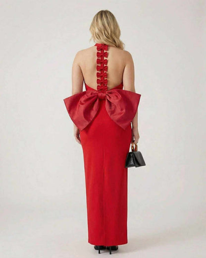 Valencia Maxi Dress by Lauven in red with a halter neck and statement bow detail at the back.