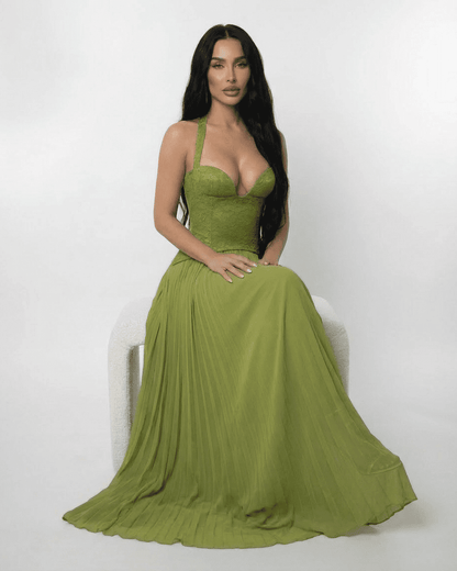 Model wearing SLIMONA Verdant Maxi Dress with lace bodice and pleated skirt in rich olive green.