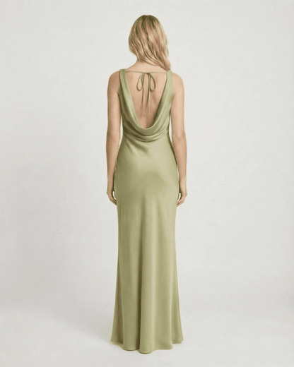 Back view of a model wearing the Verdant Maxi Dress by SLIMONA, featuring a satin-effect and elegant cowl neck.
