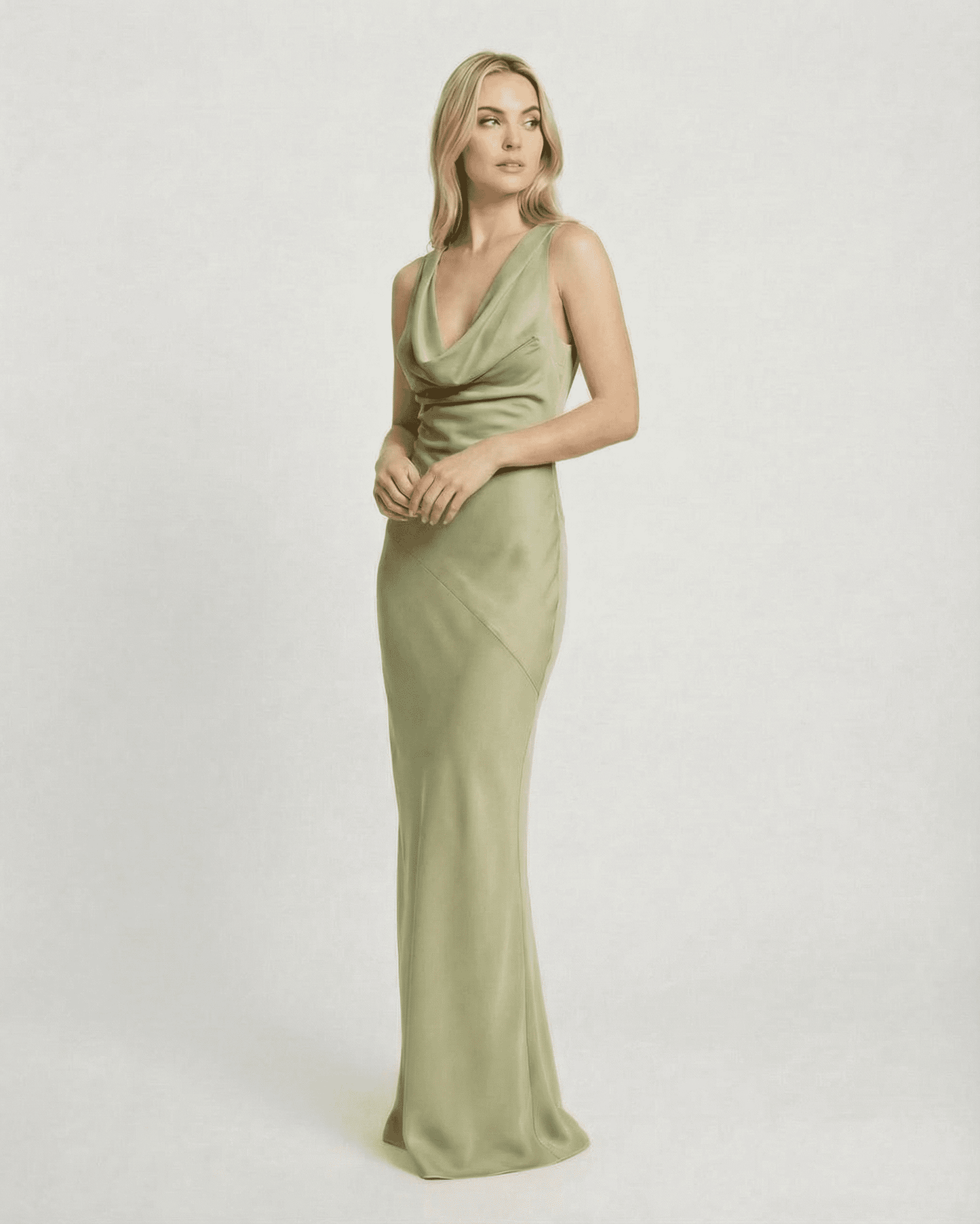 Verdant Maxi Dress by SLIMONA, showcasing a sleek satin-effect cowl neck design in soft green tones.