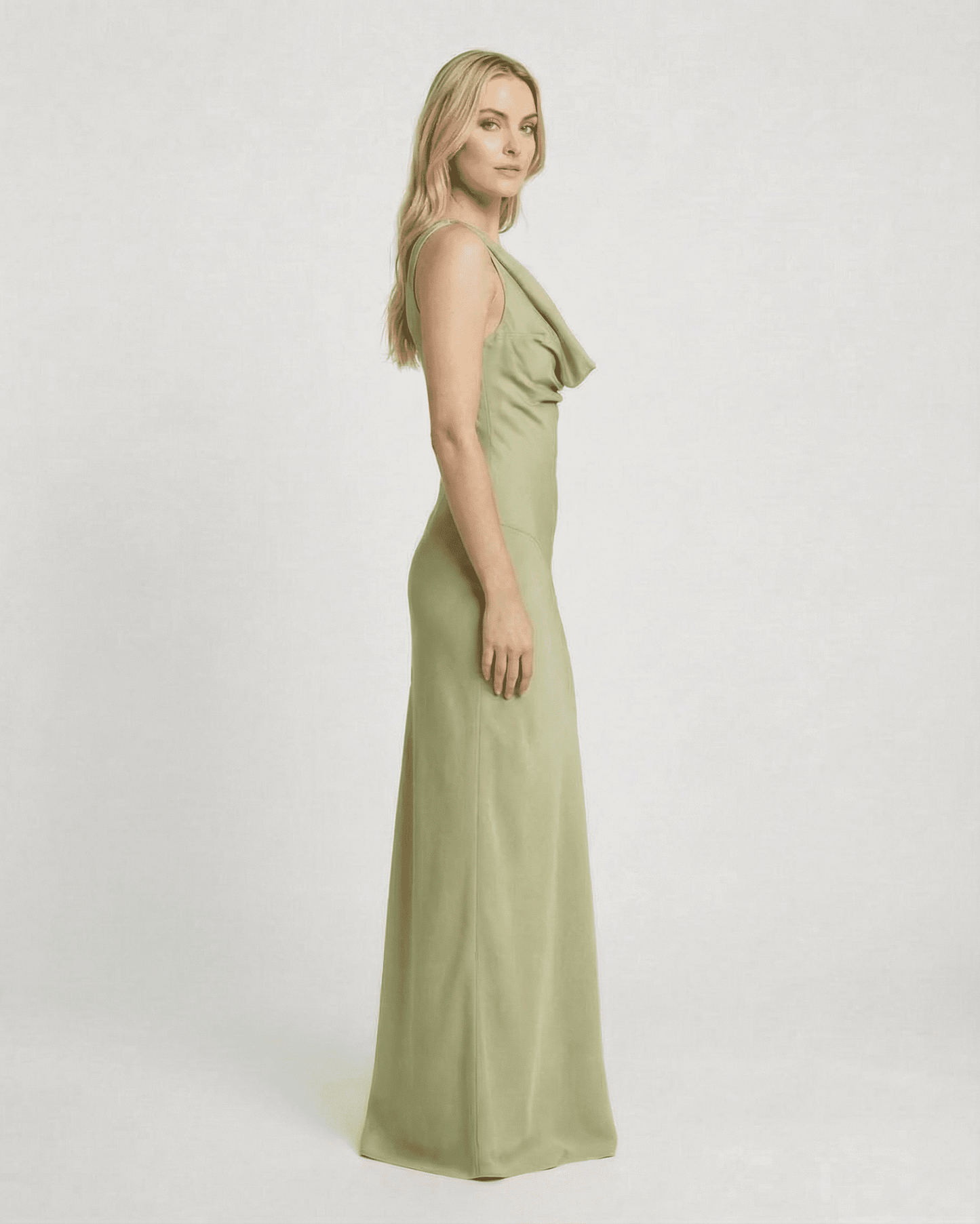 Model showcasing the Verdant Maxi Dress by SLIMONA, a sleeveless satin-effect gown in soft green.