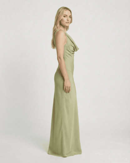 Model showcasing the Verdant Maxi Dress by SLIMONA, a sleeveless satin-effect gown in soft green.