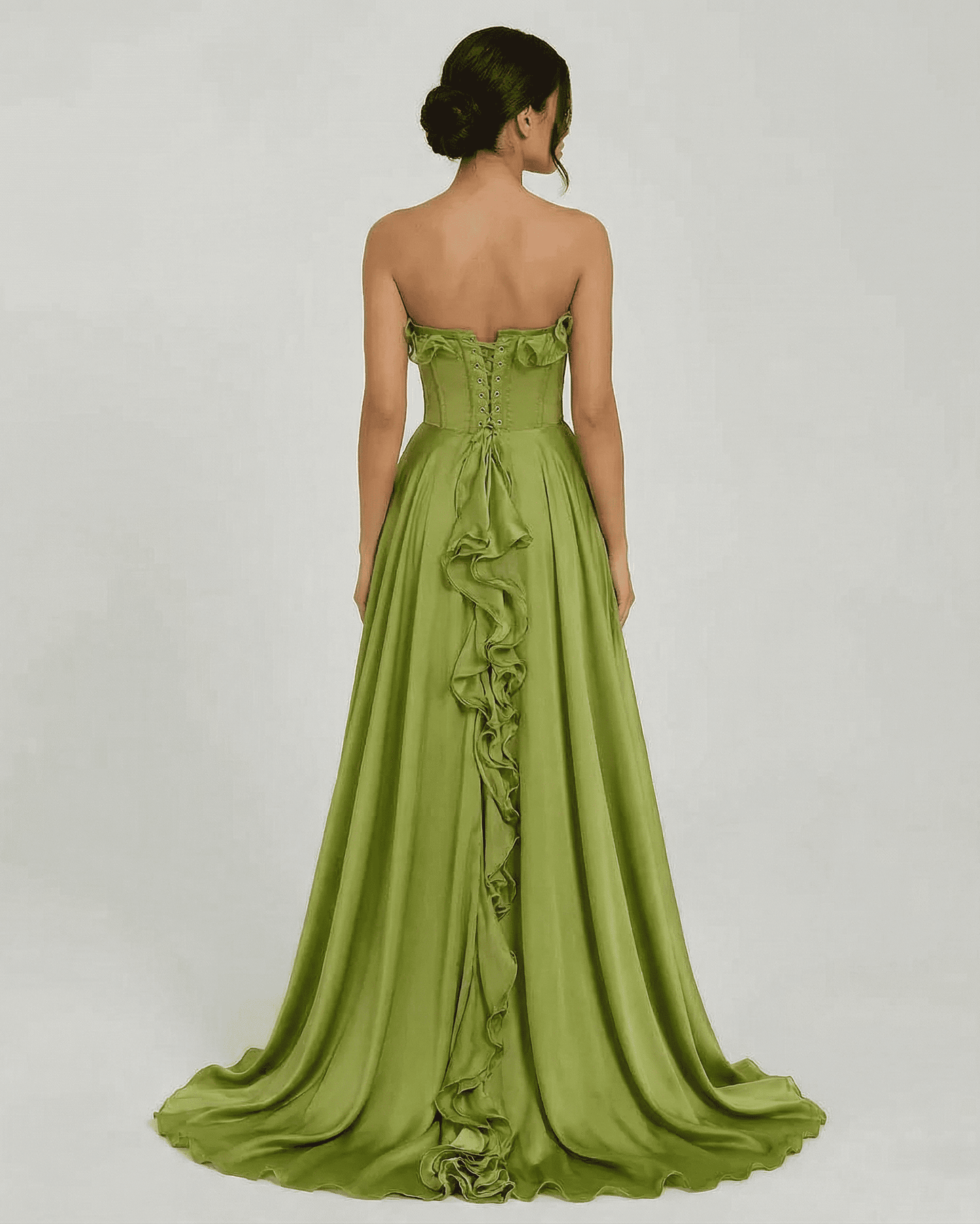 Back view of Verdessa Maxi Dress by SLIMONA, a strapless green maxi dress with ruffle detail and flowing silhouette.