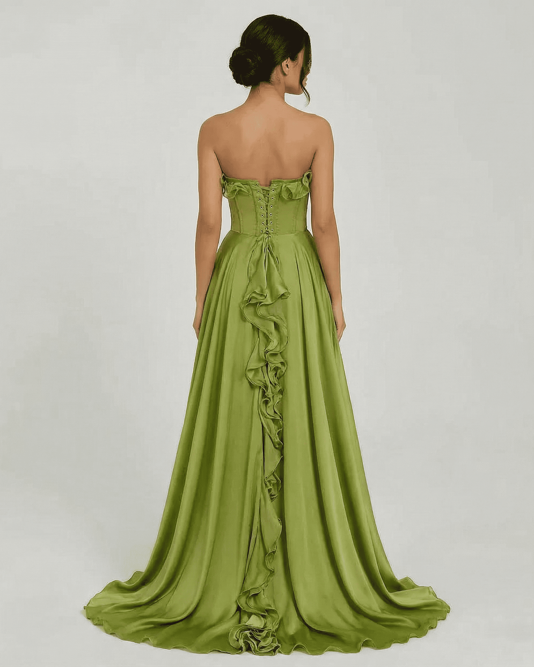 Back view of Verdessa Maxi Dress by SLIMONA, a strapless green maxi dress with ruffle detail and flowing silhouette.