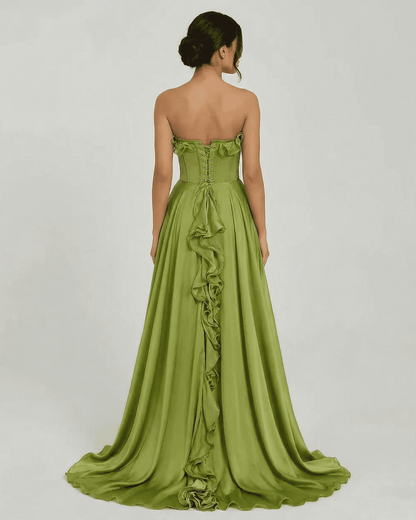 Back view of Verdessa Maxi Dress by SLIMONA, a strapless green maxi dress with ruffle detail and flowing silhouette.