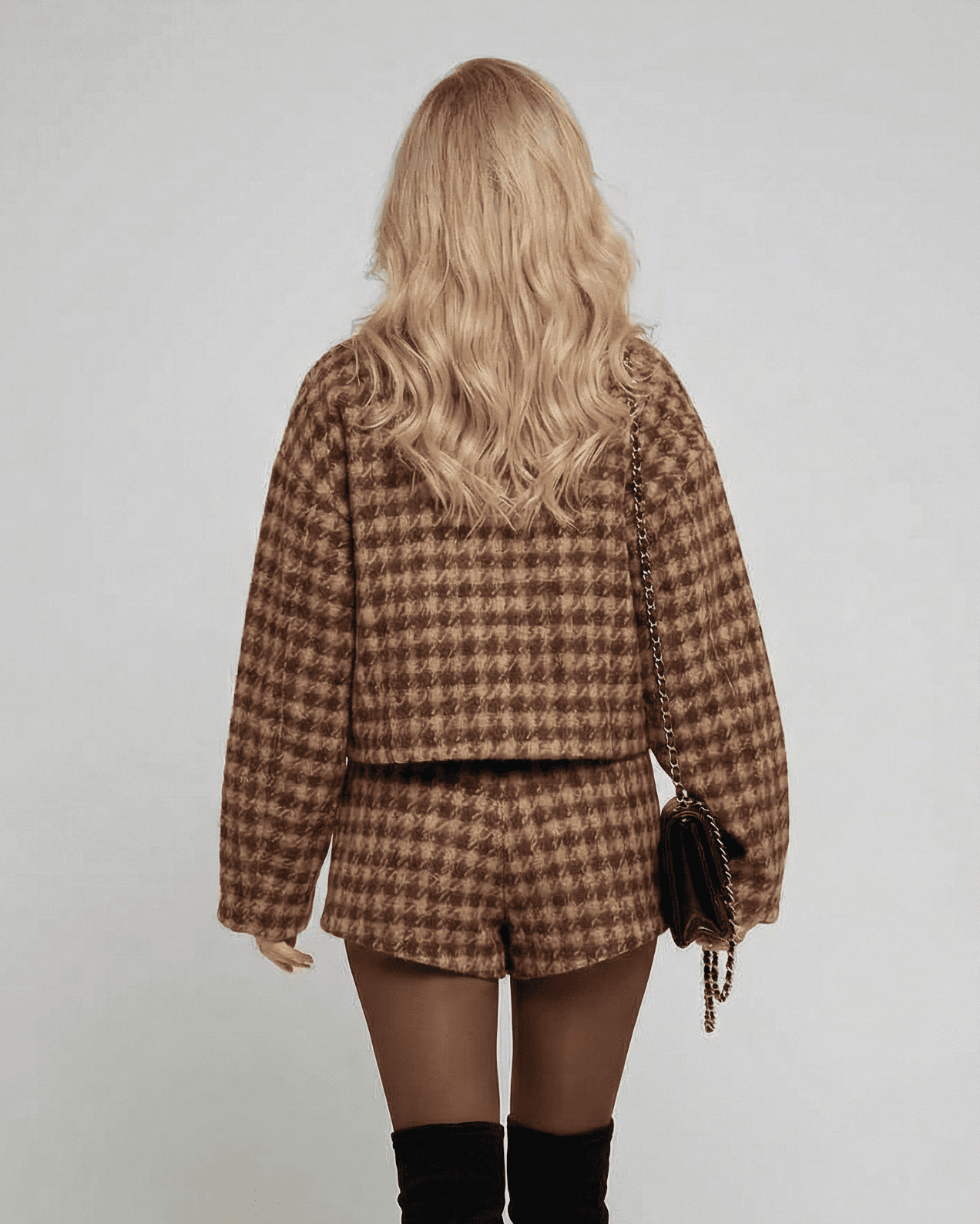 Back view of a model in the Verona Set by SLIMONA, showcasing the stylish two-piece outfit with tailored shorts.