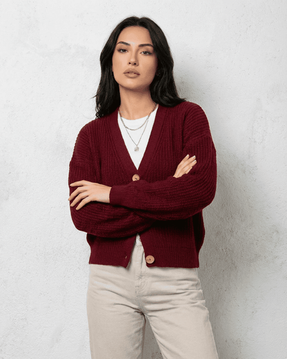 Vesper Cardigan by SLIMONA in luxurious burgundy with classic V-neck design worn by a model.