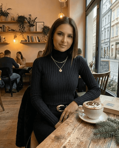 Vesper Sweater by SLIMONA — Elegant ribbed turtleneck style in black, perfect for cozy coffee shop moments.