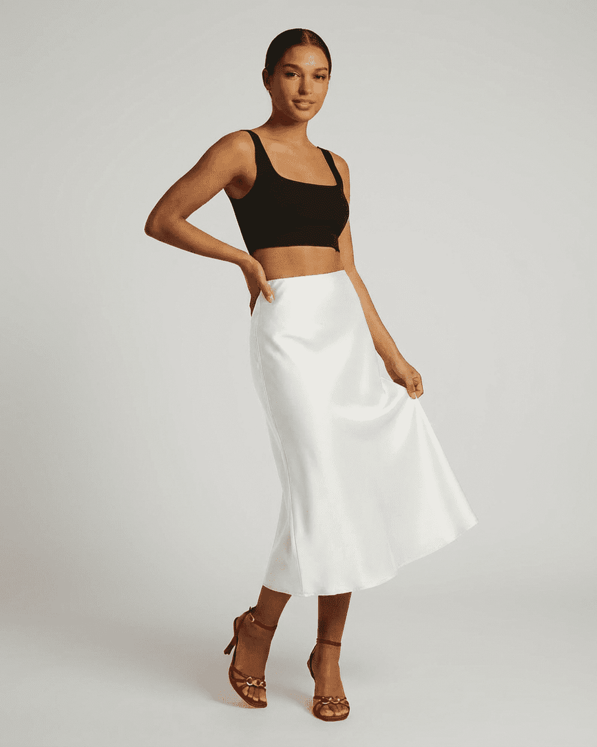 Model wearing the Luna Midi Skirt by SLIMONA, showcasing the elegant satin mermaid design in timeless white.