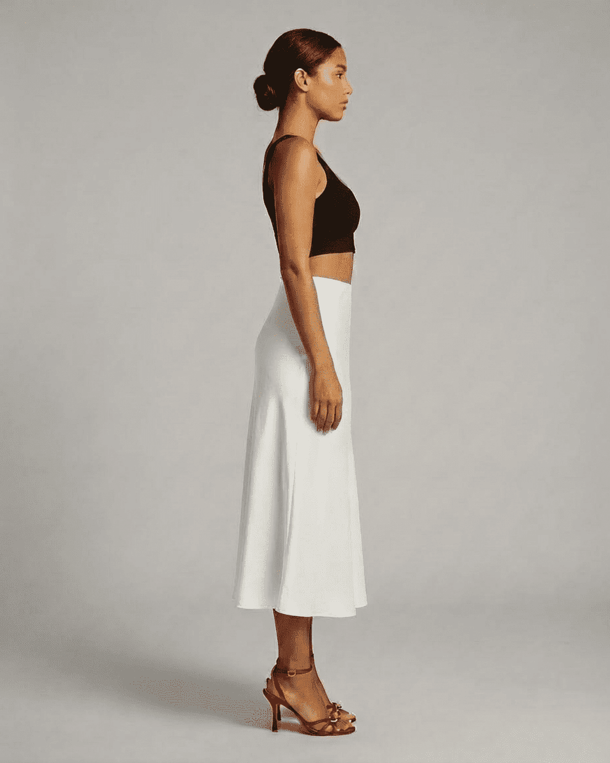 Luna Midi Skirt from SLIMONA showcased on a model, highlighting the elegant satin mermaid design in white.