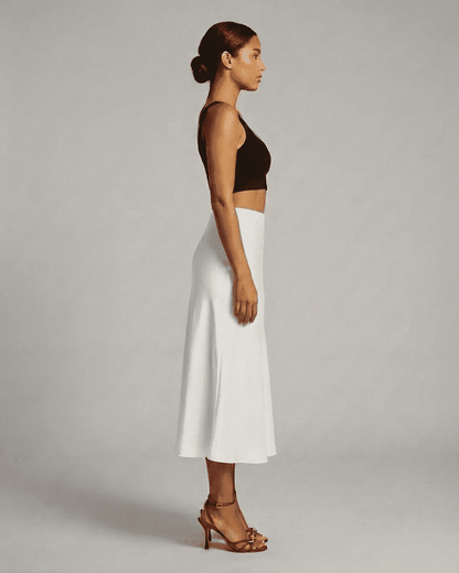 Luna Midi Skirt from SLIMONA showcased on a model, highlighting the elegant satin mermaid design in white.