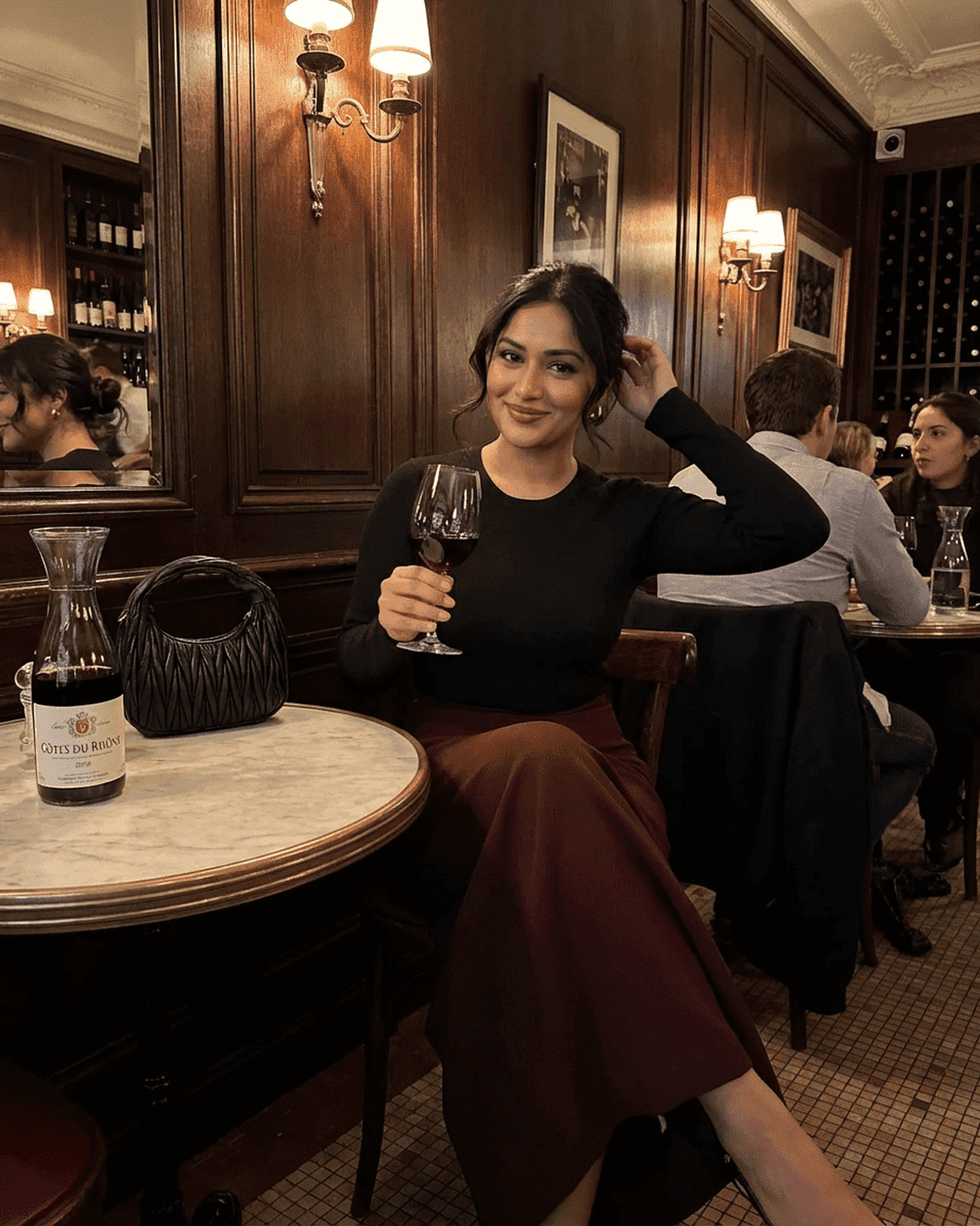 Merlot Maxi Skirt by SLIMONA, showcasing an elegant woman enjoying a drink in a chic restaurant setting.